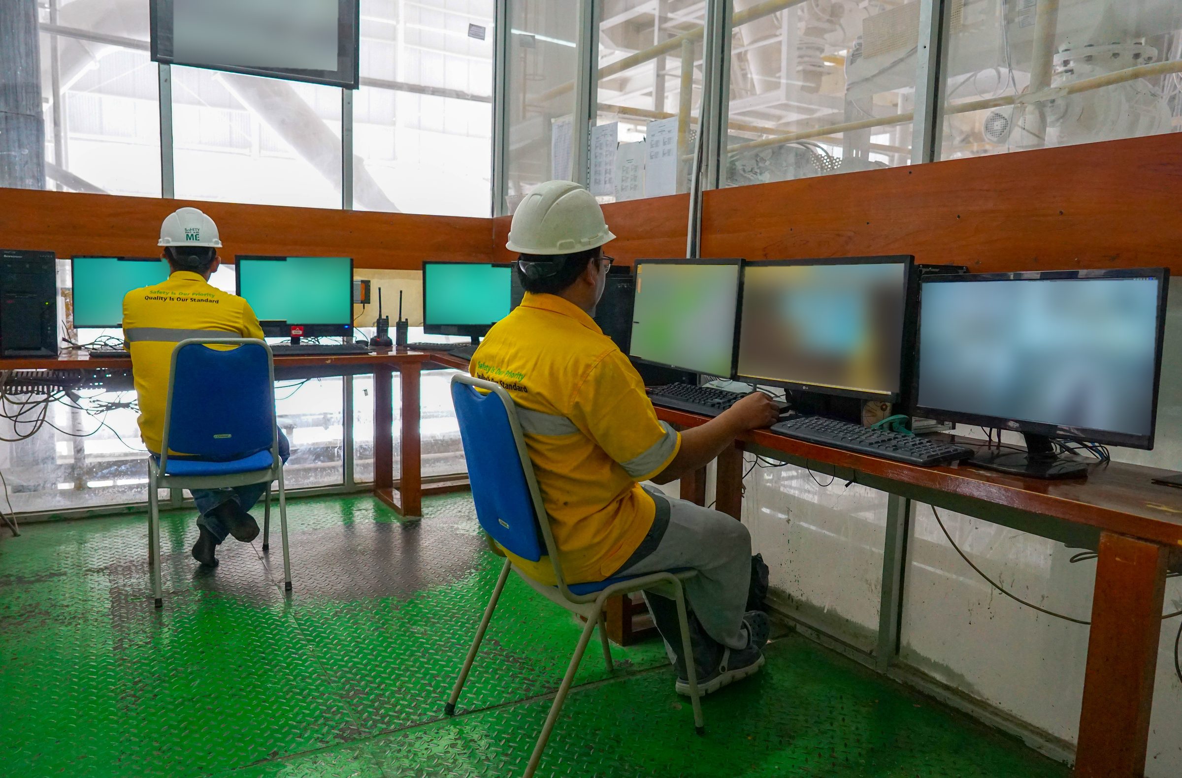 Operators monitoring the production line from the control room